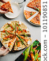 Traditional Italian pizza, vegetables, ingredients on a light background.Top view. a piece of pizza in the hand.Festive table. company of friends 101190851