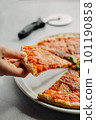 Traditional Italian pizza, vegetables, ingredients on a light background.Pizza menu. Side view. piece of pizza in hand. 101190858