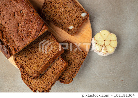 whole grain garlic bread on wooden board, banner, menu, recipe place for text, top view 101191304