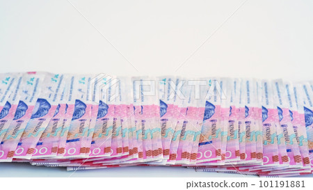 Cash money. Ukrainian hryvnia. UAH currency. Closeup of 200 hrn bill pink blue color paper banknotes pile on white empty space background. Cash money. Ukrainian hryvnia. UAH currency. Closeup of 200 hrn bill pink blue color paper banknotes pile on white empty space background. 101191881