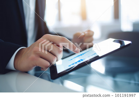 Businessman's hand operating a tablet Businessman's hand operating a tablet 101191997