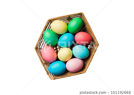 Basket of colorful Easter eggs isolated on white background. Easter basket filled with colored eggs top view holiday concept Basket of colorful Easter eggs isolated on white background. Easter basket filled with colored eggs top view holiday concept 101192668