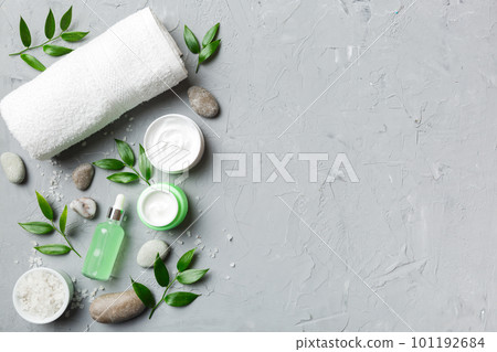 Coconut with jars of coconut oil and cosmetic cream on colored background. Top view. Free space for your text. Natural spa coconut cosmetics and organic treatment concept Coconut Spa composition 101192684