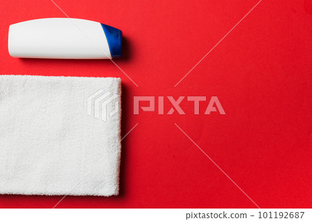 Cosmetic shampoo bottle mockup with towels on a colored table. Bathroom background, toilet accessories for hand and body care Cosmetic shampoo bottle mockup with towels on a colored table. Bathroom background, toilet accessories for hand and body care 101192687