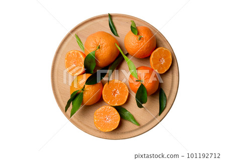 Fresh cutted clementines and whole mandarin over round plate isolated on white background. Food and drink ingredients preparing. healthy eating theme top view with copy space Fresh cutted clementines and whole mandarin over round plate isolated on white background. Food and drink ingredients preparing. healthy eating theme top view with copy space 101192712