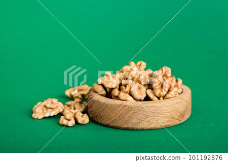 Fresh healthy walnuts in bowl on colored table background. Top view Healthy eating bertholletia concept. Super foods 101192876