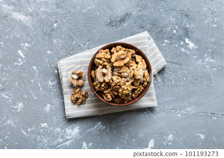 Fresh healthy walnuts in bowl on colored table background. Top view Healthy eating bertholletia concept. Super foods 101193273