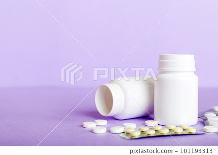 Medicine for treatment HIV infection. Pills and capsules and battle on the table. Different colorful tablets at colored background with copy space 101193313