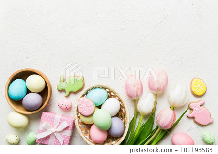 Easter frame with eggs, gift box and tulip on a colored background. The minimal concept. Top view Happy Easter composition. Card with a copy space of the place for the text Easter frame with eggs, gift box and tulip on a colored background. The minimal concept. Top view Happy Easter composition. Card with a copy space of the place for the text 101193583