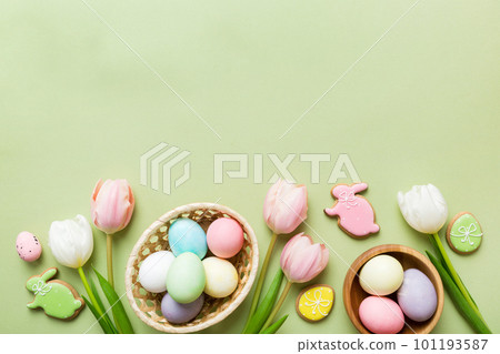 Easter frame with eggs, gift box and tulip on a colored background. The minimal concept. Top view Happy Easter composition. Card with a copy space of the place for the text Easter frame with eggs, gift box and tulip on a colored background. The minimal concept. Top view Happy Easter composition. Card with a copy space of the place for the text 101193587