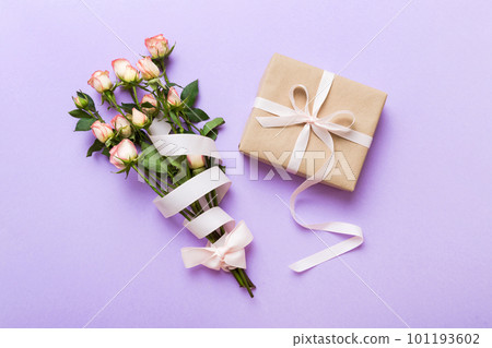 design concept with pink rose flower and gift box on colored table background top view. Happy Holiday, Mothers day, birthday concept. Romantic flat lay composition 101193602