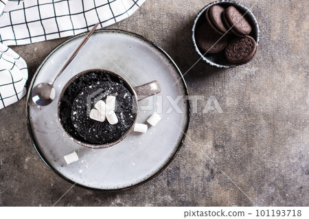 Chocolate cake in a mug with marshmallows and powdered sugar for homemade dessert top view Chocolate cake in a mug with marshmallows and powdered sugar for homemade dessert top view 101193718