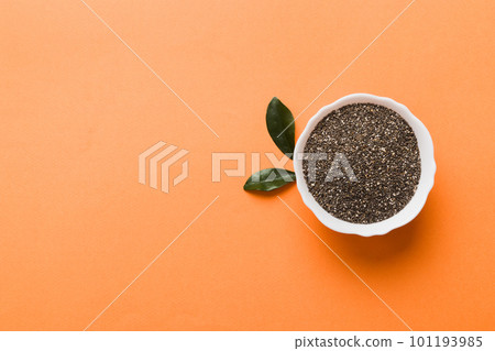 Chia seeds in bowl on colored background. Healthy Salvia hispanica in small bowl. Healthy superfood Chia seeds in bowl on colored background. Healthy Salvia hispanica in small bowl. Healthy superfood 101193985
