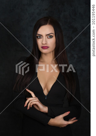 Beautiful dark-haired brunette with a deep neckline in a gothic style 101195446