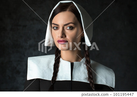 Gothic woman with pigtails in a medieval collar and cap 101195447