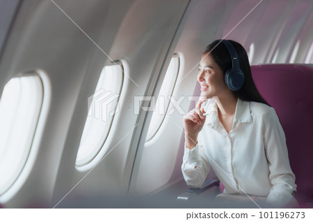 Beautiful Asian businesswoman working with digital tablet in aeroplane. working, travel, business concept Beautiful Asian businesswoman working with digital tablet in aeroplane. working, travel, business concept 101196273