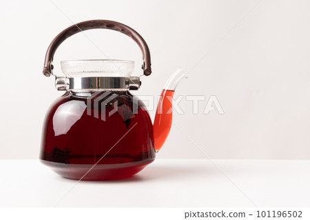 Red hibiscus tea from the petals of a Sudanese rose in a glass teapot, copy the place for the text 101196502