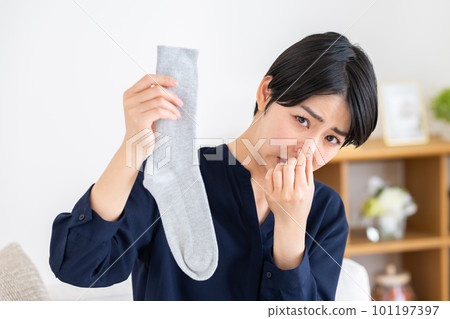 young woman with stinky socks 101197397