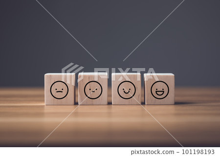 Sad face to smile face on wooden blocks cube arranged on wooden table. Idea of manythink to face and smile in finally. Sad face to smile face on wooden blocks cube arranged on wooden table. Idea of manythink to face and smile in finally. 101198193