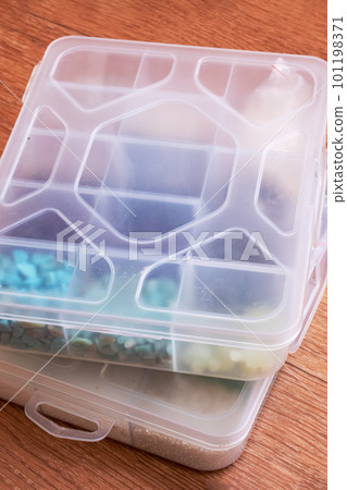 Small storage containers on a wooden floor Small storage containers on a wooden floor 101198371