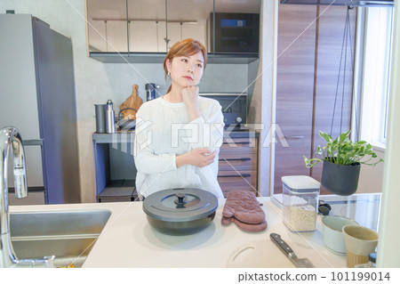 A woman thinking of a meal A woman thinking of a meal 101199014