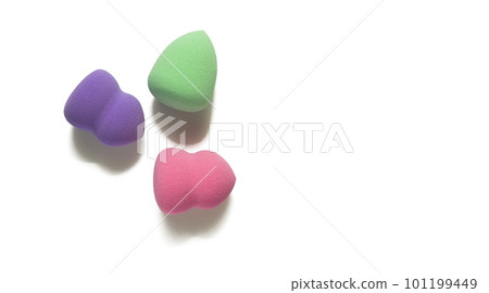 Colored makeup sponges purple, pink, green on a white background. Means for applying professional make-up 101199449