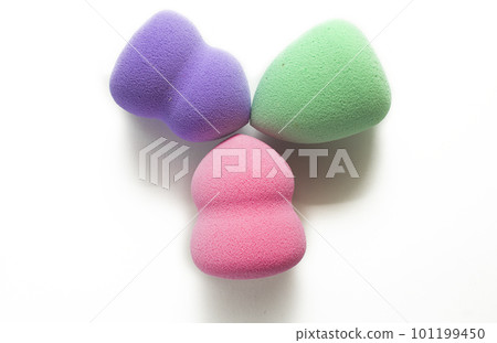 Colored makeup sponges purple, pink, green on a white background. Means for applying professional make-up 101199450
