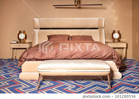 Bedroom interior in pastel brown tones with velvet and velor headboard. Bedroom interior in pastel brown tones with velvet and velor headboard. 101200556