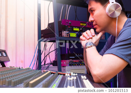 asian male professional music producer, sound engineer working in sound studio. music production concept 101201513
