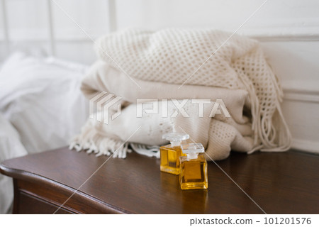 Two glass bottles with perfume or perfume in vintage style on the bedside table Two glass bottles with perfume or perfume in vintage style on the bedside table 101201576