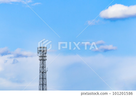 Landscape of a steel tower with a blue sky and base station antennas 101201586