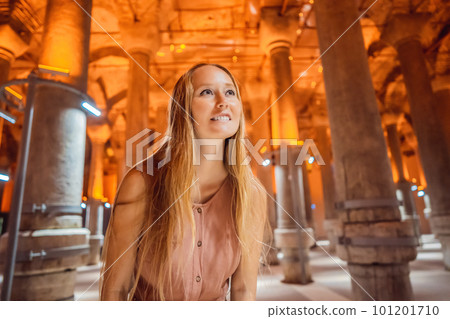 Woman tourist enjoying Beautiful cistern in Istanbul. Cistern - underground water reservoir build in 6th century, Istanbul, Turkey, Turkiye Woman tourist enjoying Beautiful cistern in Istanbul. Cistern - underground water reservoir build in 6th century, Istanbul, Turkey, Turkiye 101201710