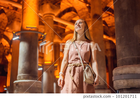 Woman tourist enjoying Beautiful cistern in Istanbul. Cistern - underground water reservoir build in 6th century, Istanbul, Turkey, Turkiye Woman tourist enjoying Beautiful cistern in Istanbul. Cistern - underground water reservoir build in 6th century, Istanbul, Turkey, Turkiye 101201711