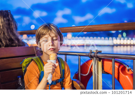 Boy tourist boy eating turkish ice cream by ferry in the Bosphorus. Traveling with kids concept 101201714