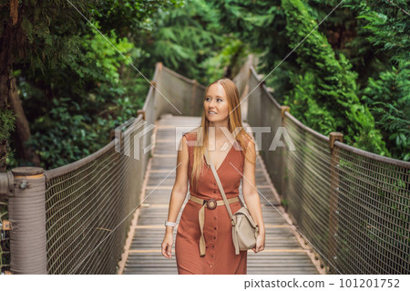 Woman tourist in Rope bridge in Yildiz Park. Besiktas, Istanbul, Turkey. Turkiye Woman tourist in Rope bridge in Yildiz Park. Besiktas, Istanbul, Turkey. Turkiye 101201752