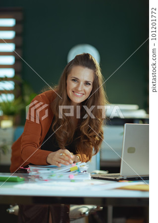 business owner woman in green office working with documents 101201772