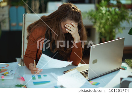 business owner woman in green office working with documents 101201774