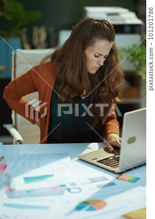 stressed business owner woman in green office stressed business owner woman in green office 101201786