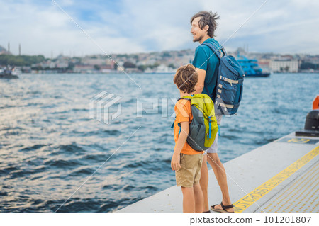 Boy and father tourists enjoying Galataport area view, cruise port of Istanbul newly opening in 2021, located in the shores of the Galata, Karakoy in Istanbul. Traveling with kids concept 101201807