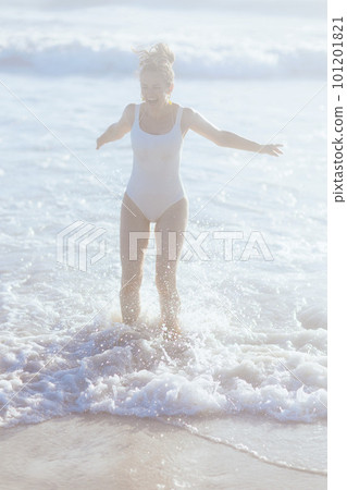 happy modern woman in white beachwear at beach having fun time 101201821