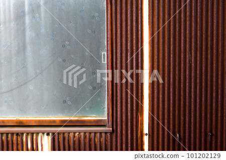 Rusted tin and old window glass 101202129
