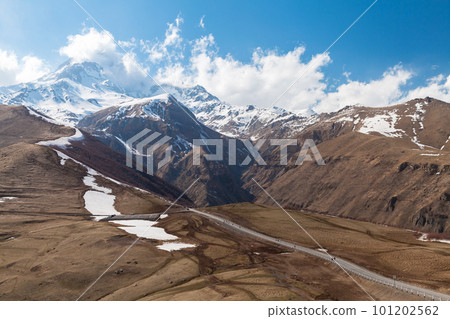 Georgian landscape with Georgian Military Road on a sunny day Georgian landscape with Georgian Military Road on a sunny day 101202562