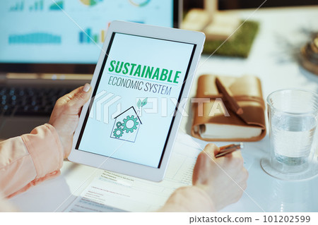 Seen from behind modern female with digital tablet Seen from behind modern female with digital tablet 101202599