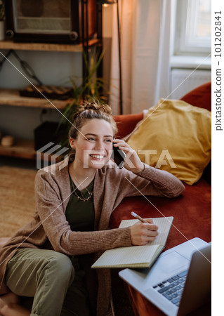 Young woman having home office in her apartment. Young woman having home office in her apartment. 101202841