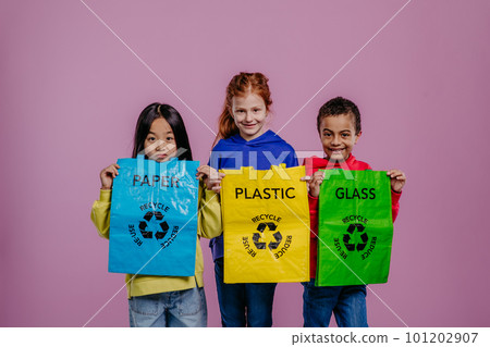 Portrait of three children posing with bins for separated waste. Portrait of three children posing with bins for separated waste. 101202907