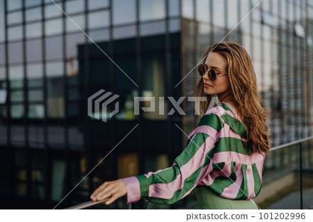 Portrait of beautiful young woman outdoor in city, during sunset. Portrait of beautiful young woman outdoor in city, during sunset. 101202996