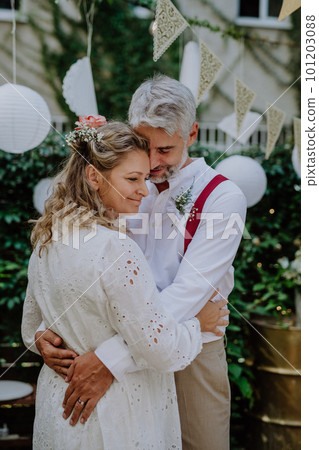Close-up of bride and groom dancing at their outdoor wedding party. 101203088