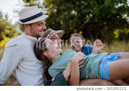 Happy lying and hugging on a medow, resting after hiking in nature. Happy lying and hugging on a medow, resting after hiking in nature. 101203111