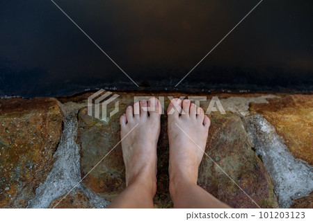 Close up of feets standing in wooden pier near the lake, summer day, holiday and vacations concept. 101203123