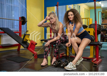 Colleagues relax after doing a very exhausting workout at the gym Colleagues relax after doing a very exhausting workout at the gym 101203180